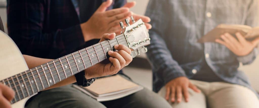 Young Men Playing Worship on Guitar