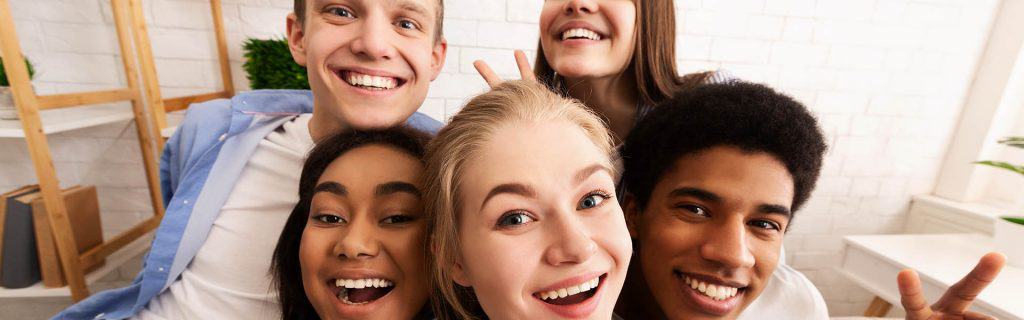 Teenagers together smiling for selfie together